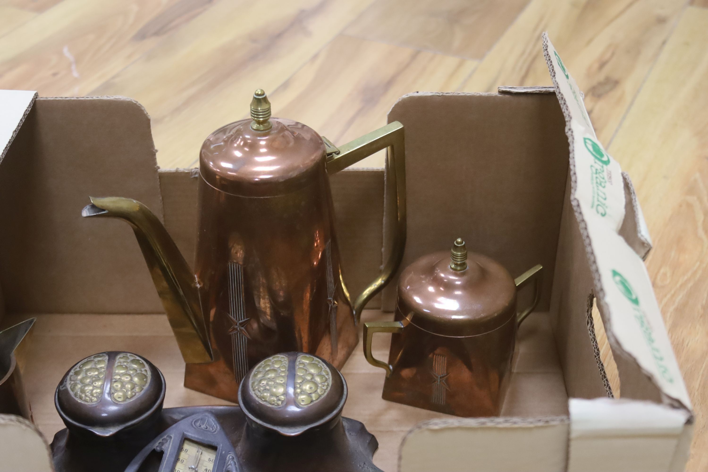 A group of early 20th century metalware including a copper and brass tea set